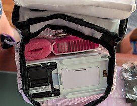 Bottom of oxygen machine inside backpack with fan & pool noodle